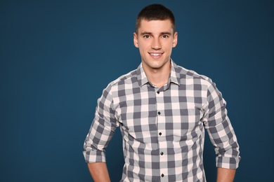 Photo of Portrait of handsome young man on blue background