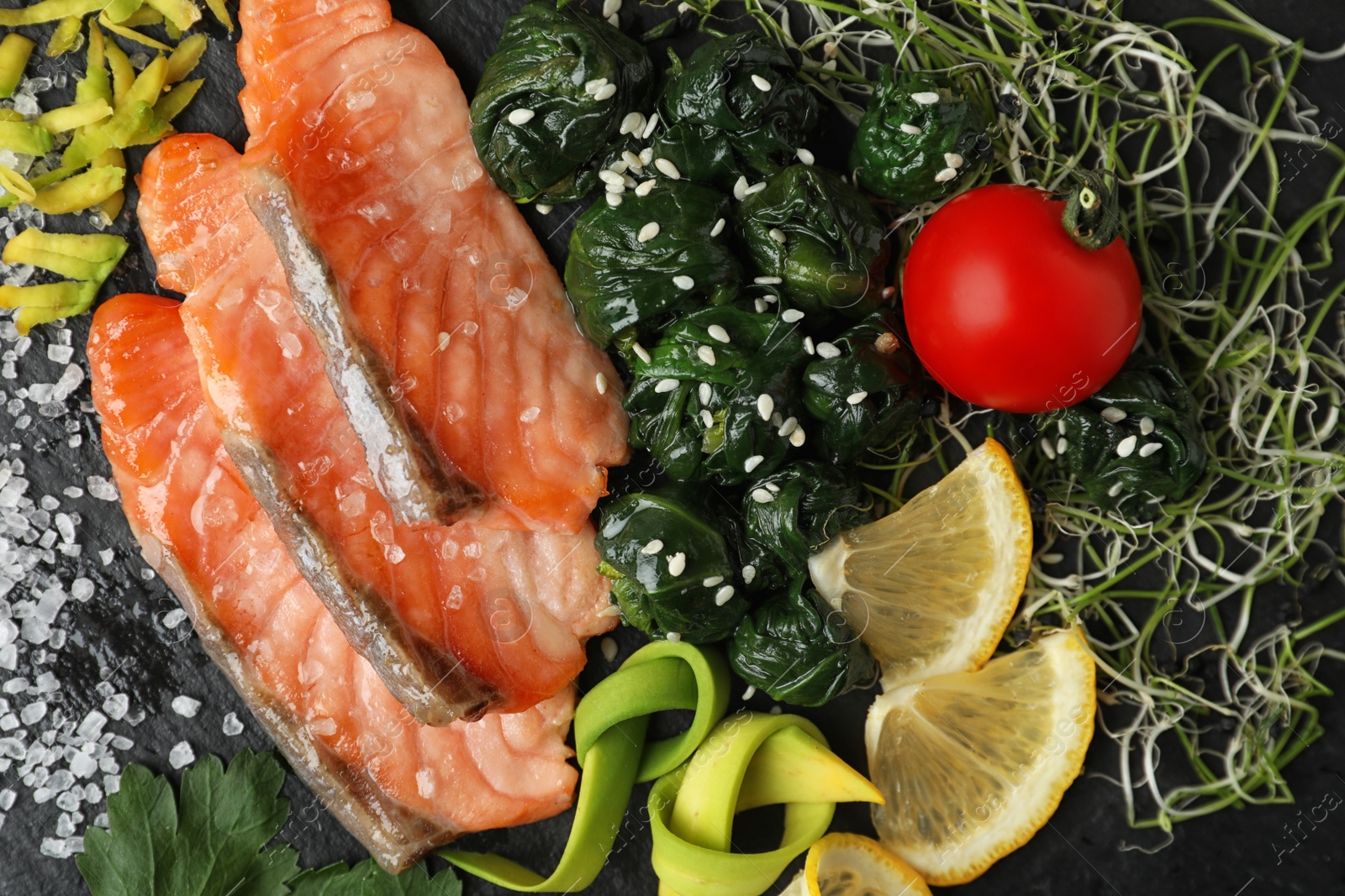 Photo of Tasty freshly cooked salmon with spinach, closeup