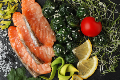 Photo of Tasty freshly cooked salmon with spinach, closeup