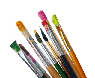 Photo of Different brushes with paints on white background