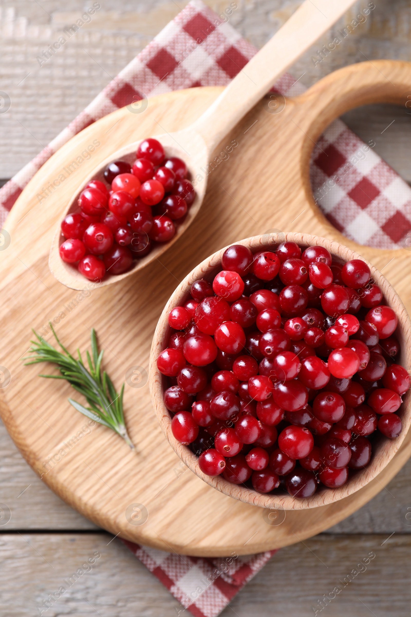 Photo of Fresh ripe cranberries on wooden table, top view