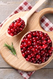 Photo of Fresh ripe cranberries on wooden table, top view