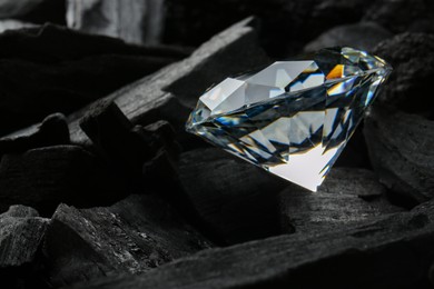 Beautiful shiny diamond on coal, closeup view