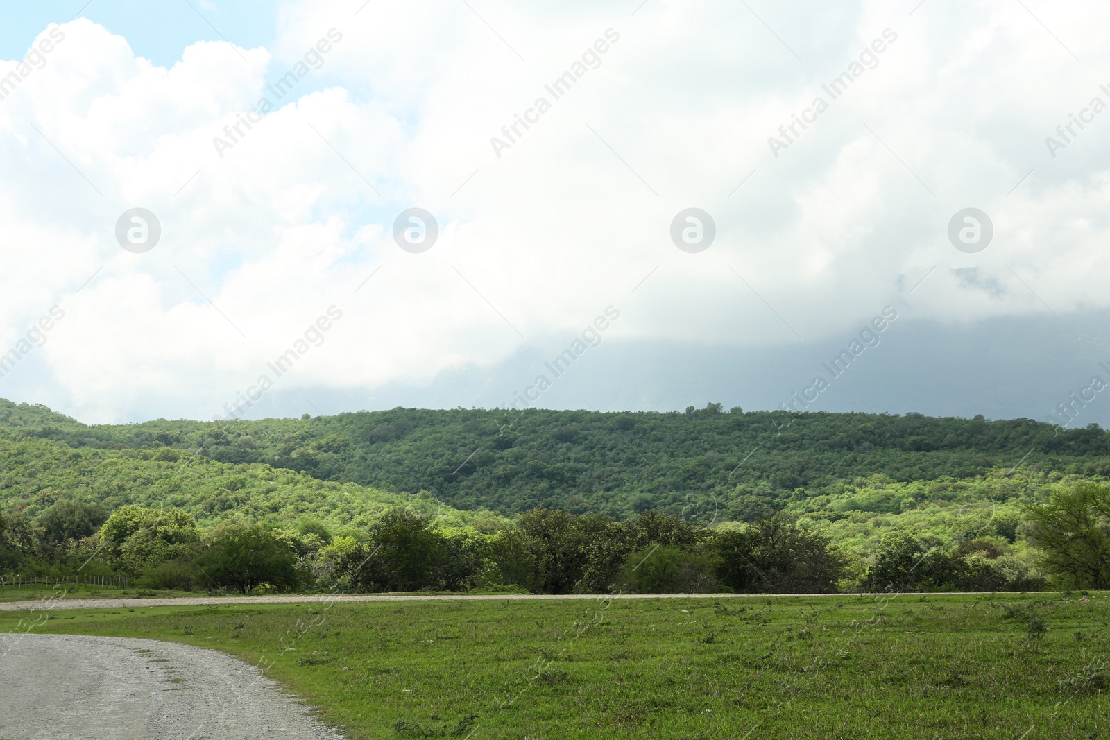 Photo of Picturesque view of mountains and green meadow