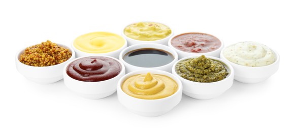 Many different sauces in bowls on white background