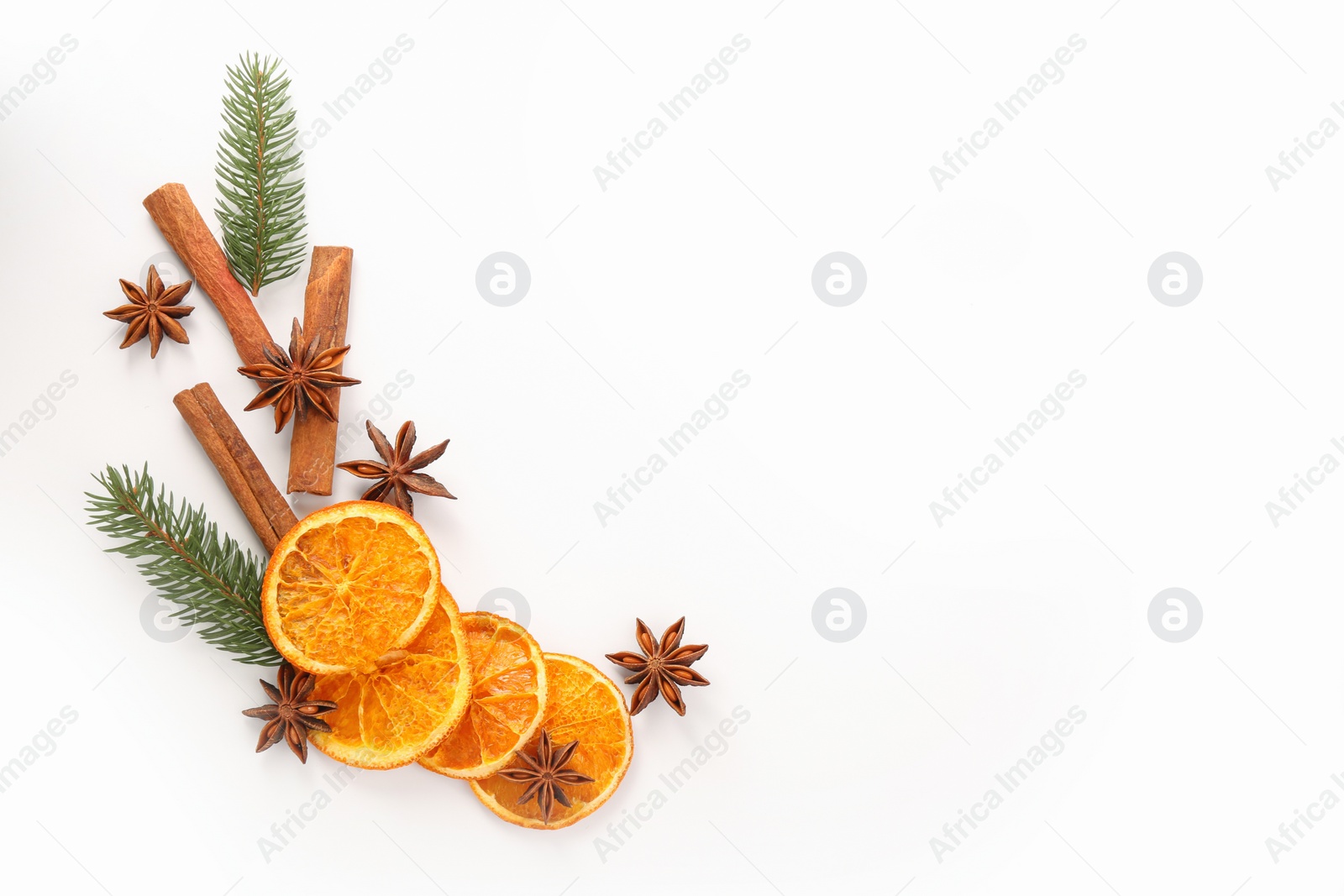 Photo of Flat lay composition with dry orange slices, anise stars and cinnamon sticks on white background. Space for text