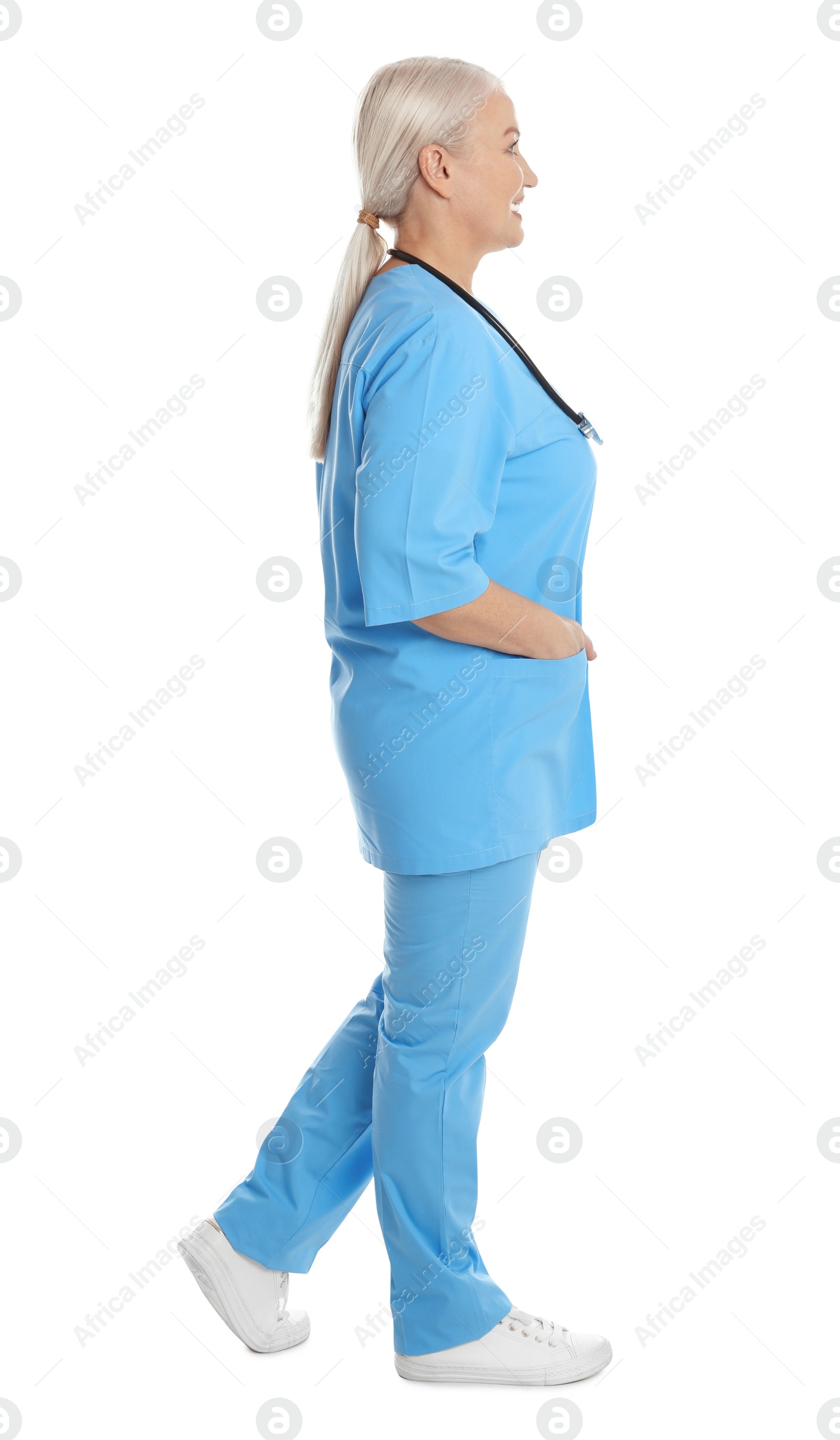 Photo of Full length portrait of mature doctor on white background