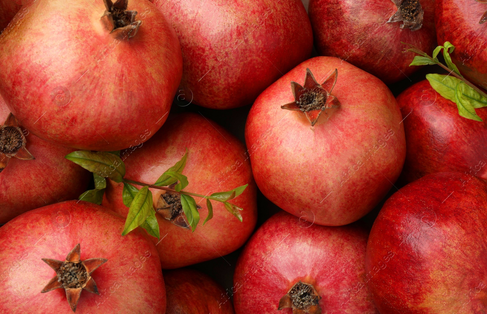 Photo of Fresh ripe pomegranates as background, top view