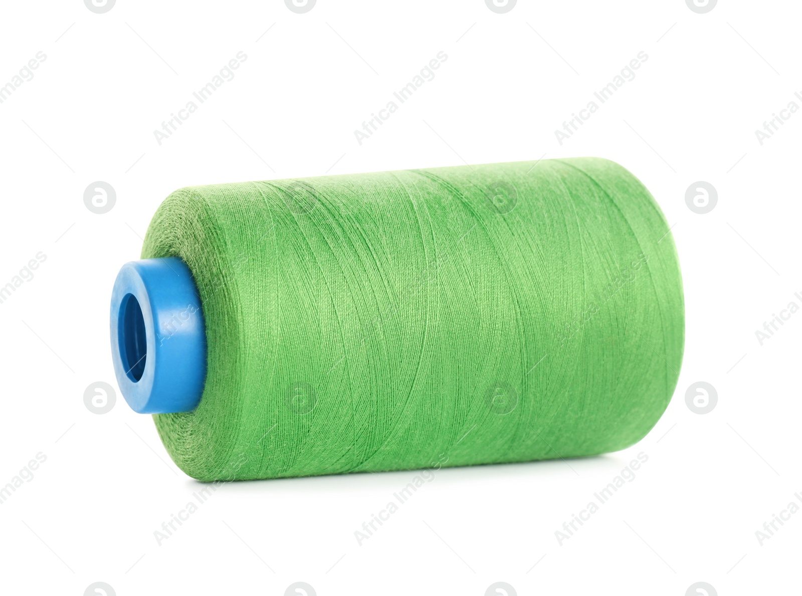 Photo of Spool of green sewing thread isolated on white