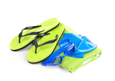 Photo of Swimming cap, goggles, flip flops and towel isolated on white