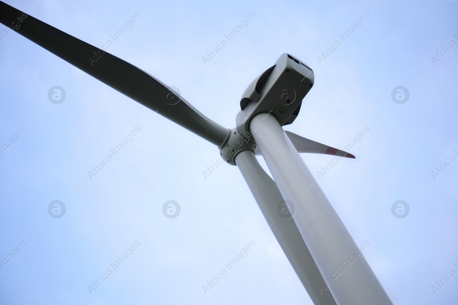 Photo of Wind turbine against beautiful sky, closeup. Alternative energy source