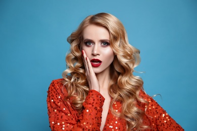 Photo of Portrait of surprised woman on blue background