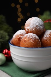 Photo of Delicious sweet buns in bowl and decor on table, closeup