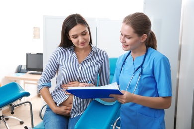 Photo of Pregnant woman having appointment at gynecologist office