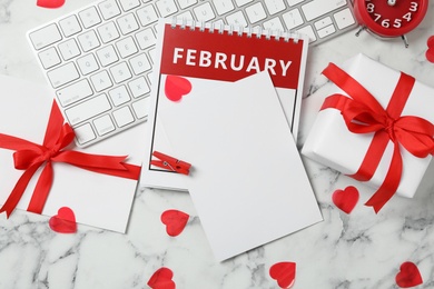 Photo of Flat lay composition with blank card on white marble table, space for text. Valentine's Day celebration