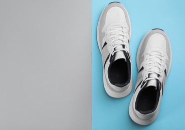 Pair of stylish sneakers on color background, flat lay. Space for text