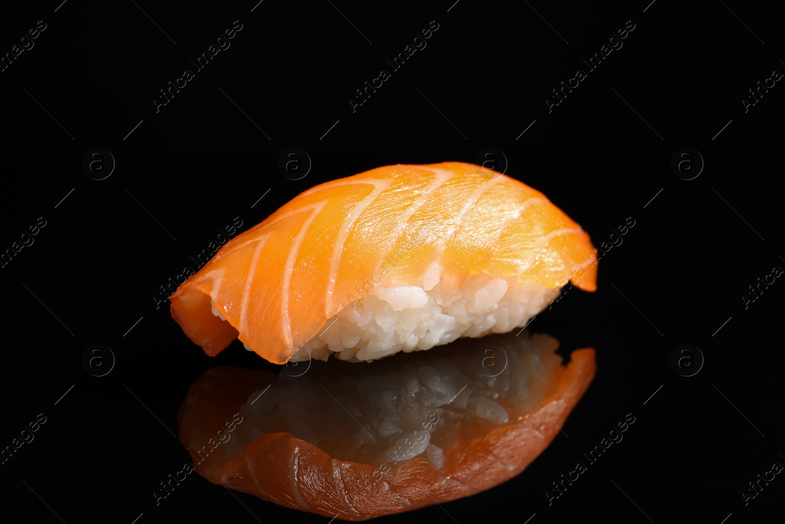 Photo of Delicious nigiri sushi with salmon on black background