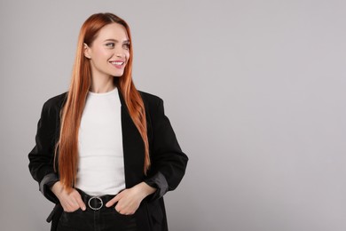 Photo of Portrait of beautiful young woman on light gray background, space for text