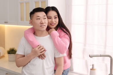 Photo of Portrait of lovely young couple in kitchen