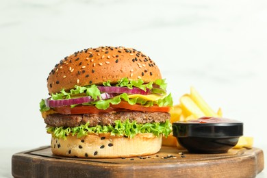 Photo of Burger with delicious patty, french fries and sauce on table against light background, closeup