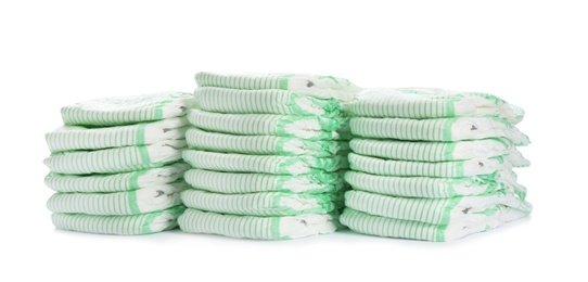 Photo of Stacks of diapers on white background. Baby accessories