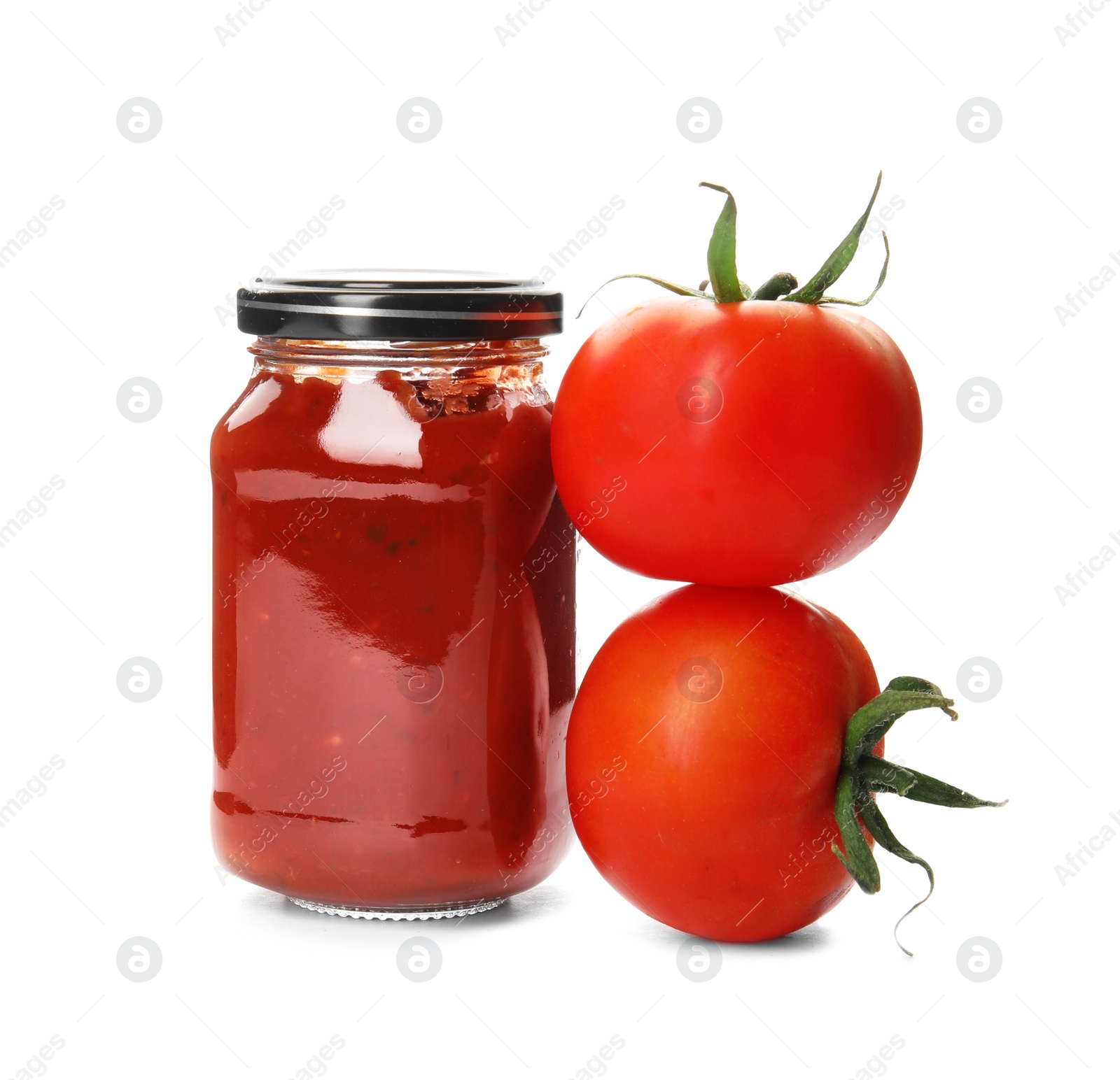 Photo of Tasty homemade tomato sauce in glass jar and fresh vegetables on white background