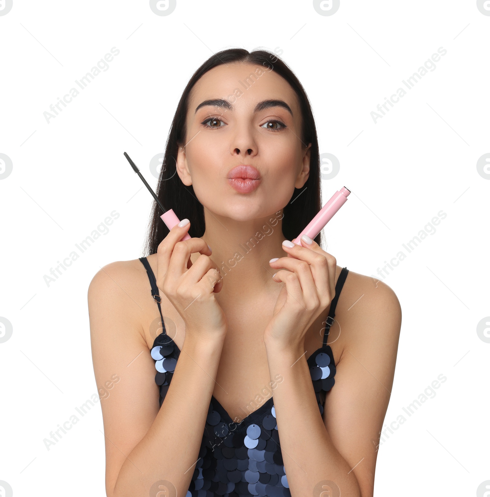 Photo of Beautiful young woman with mascara sending air kiss on white background