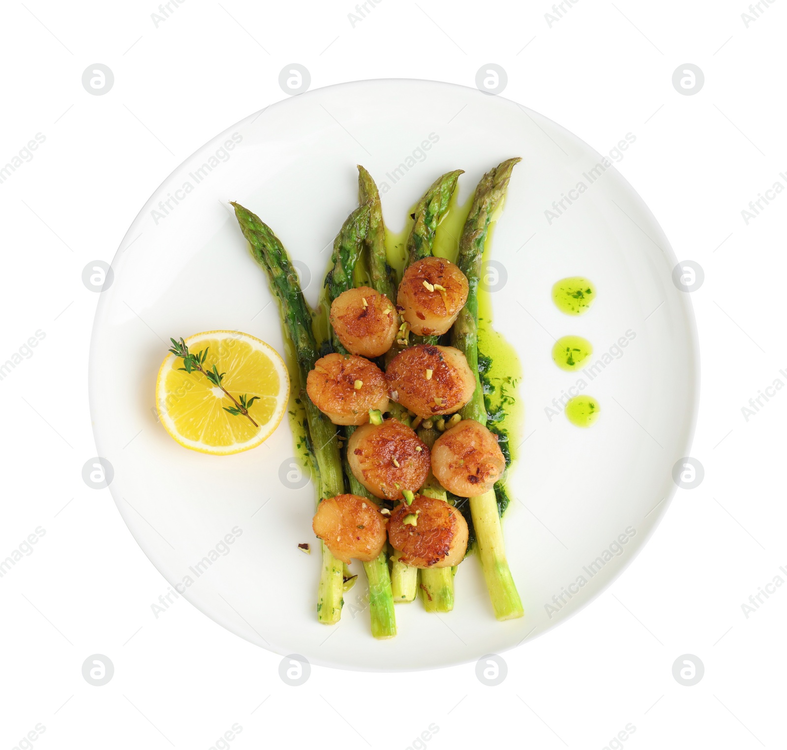 Photo of Delicious fried scallops with asparagus, lemon and thyme isolated on white, top view