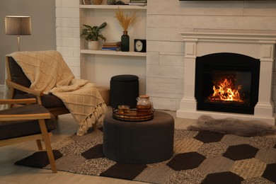 Photo of Cozy living room interior with comfortable armchairs and decorative fireplace