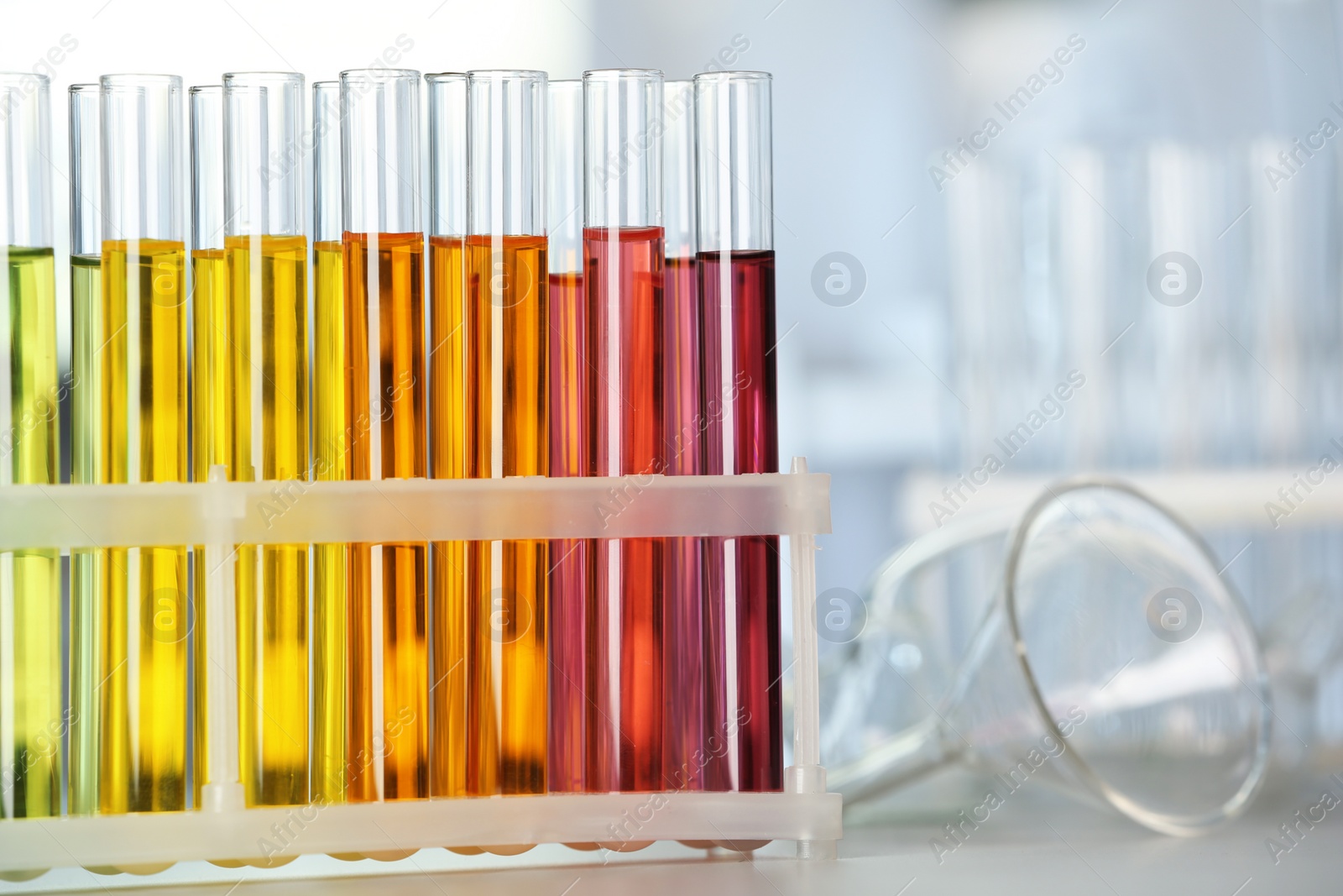 Photo of Test tubes with color liquids on table in laboratory