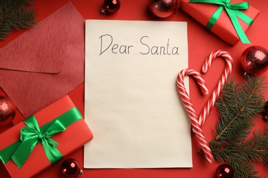 Photo of Flat lay composition with letter saying Dear Santa on red background. Space for text