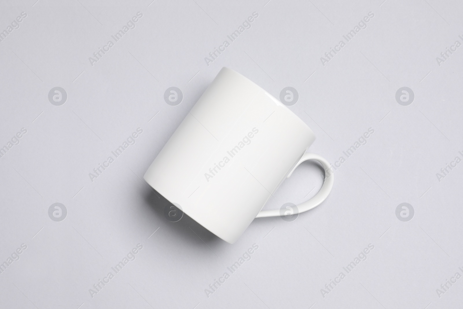 One white ceramic mug on light background, top view Photo of One white ceramic mug on light background, top view