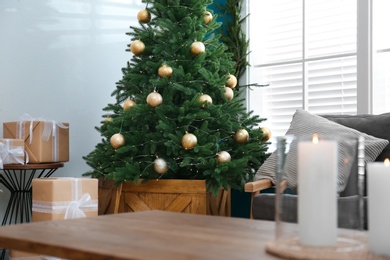 Photo of Beautiful decorated Christmas tree in living room