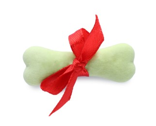Photo of Bone shaped dog cookie with red bow isolated on white, top view