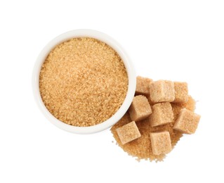 Granulated and cubed brown sugar with bowl on white background, top view