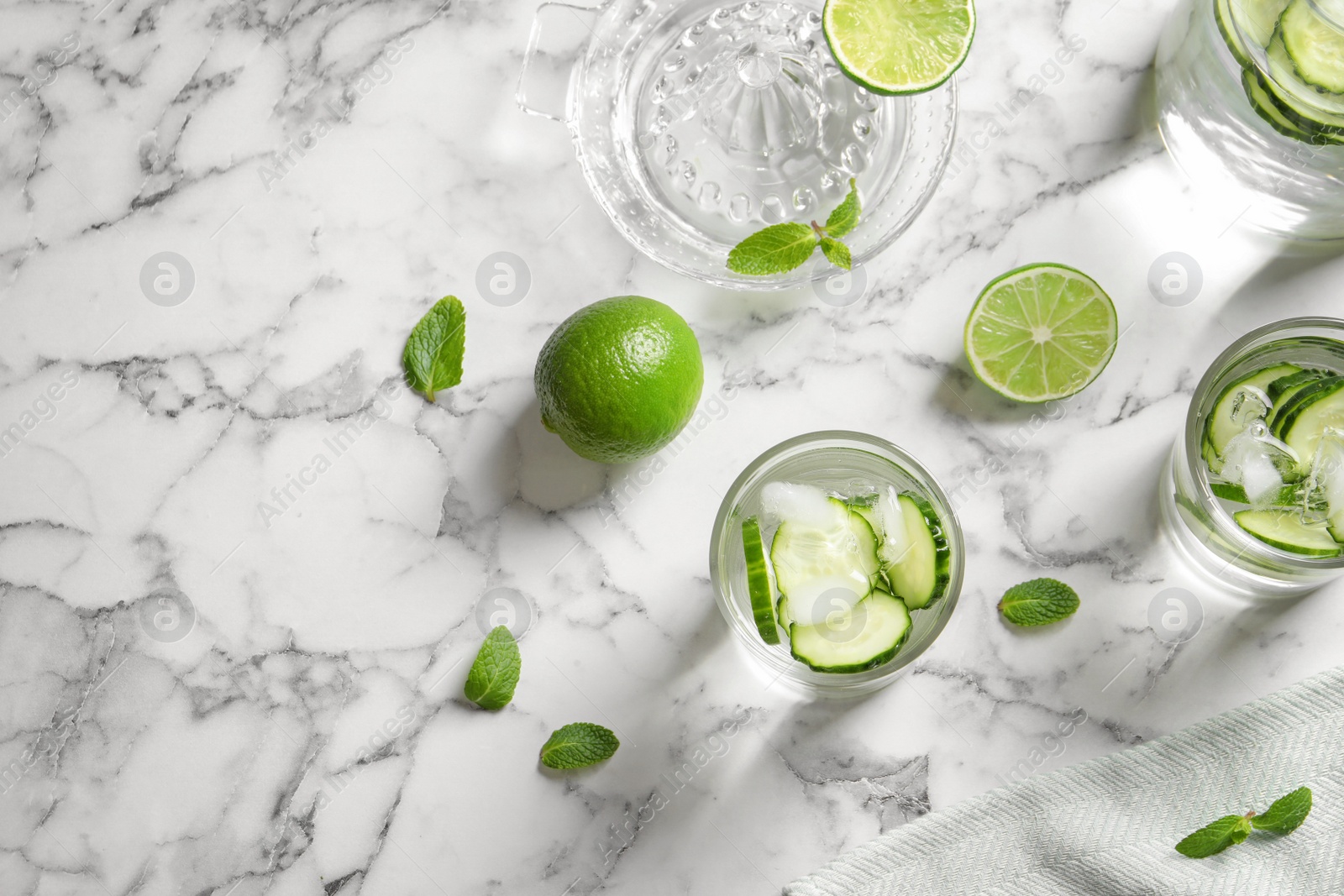 Photo of Flat lay composition with glasses of cucumber water on table. Space for text