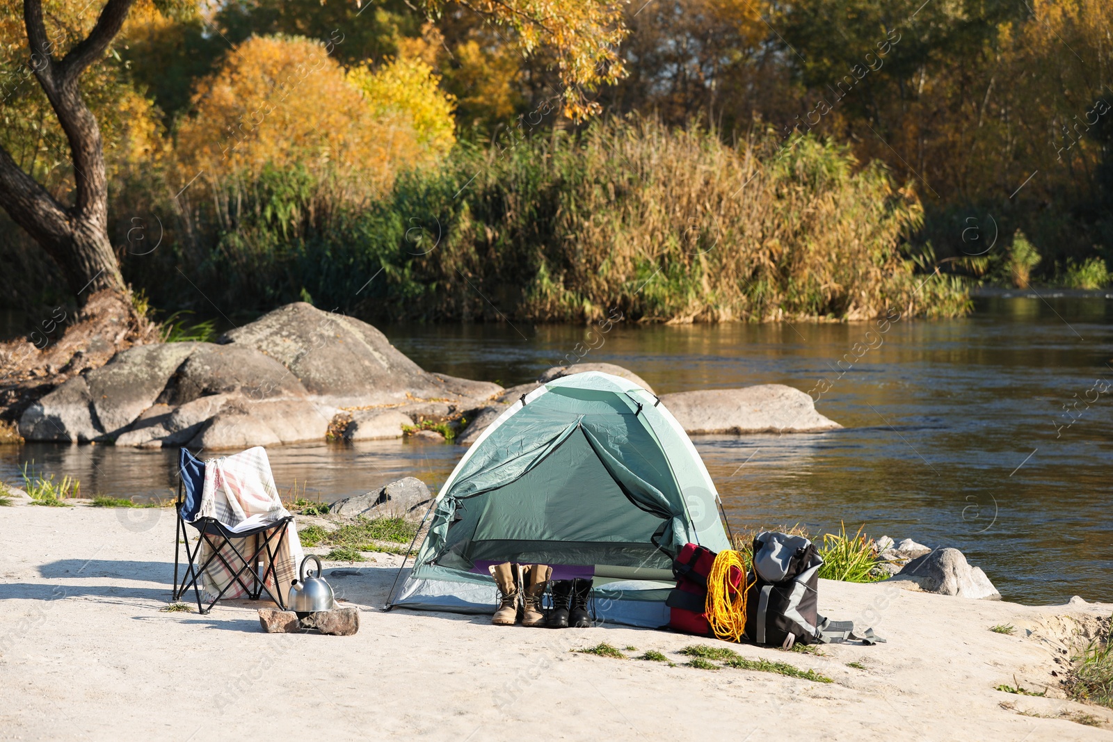 Photo of Set of equipment near camping tent outdoors