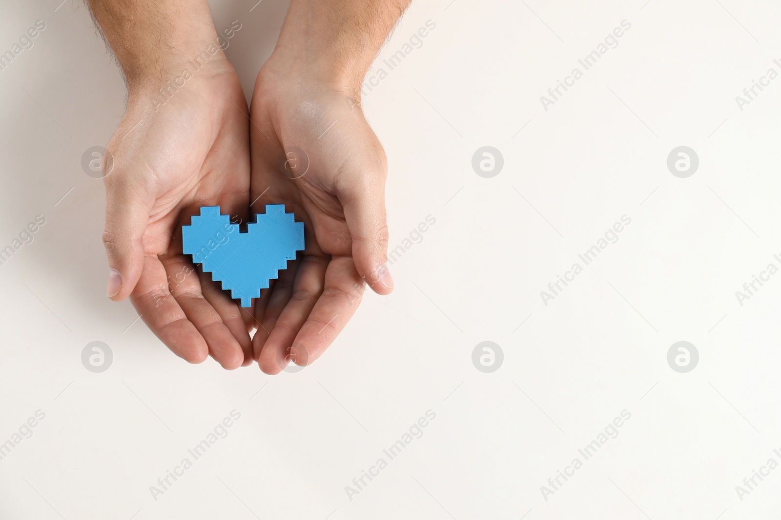 Photo of Man holding decorative heart on white background, top view with space for text