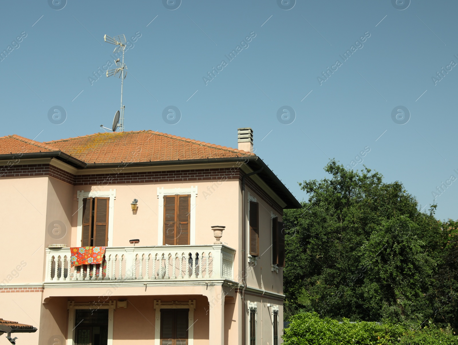 Photo of Beautiful residential building with balcony on sunny day