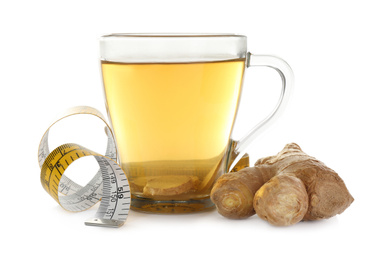 Photo of Diet herbal tea, ginger and measuring tape on white background