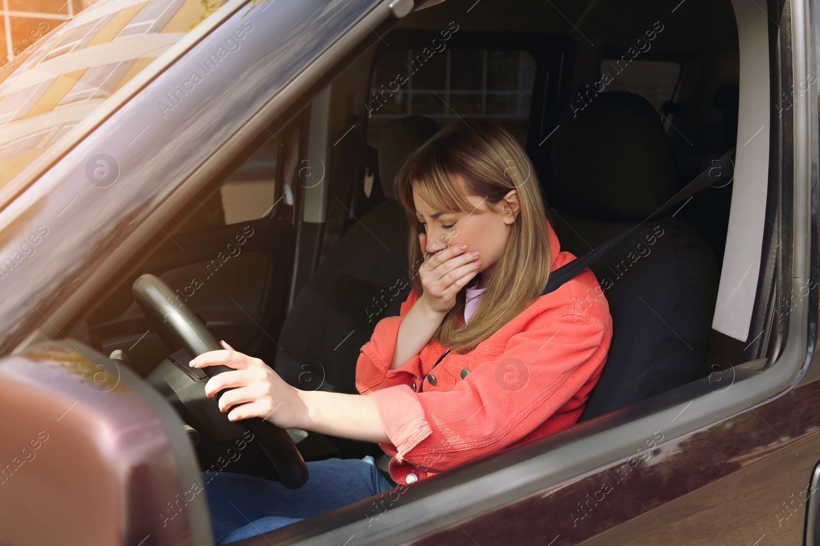 Photo of Young woman suffering from nausea in car