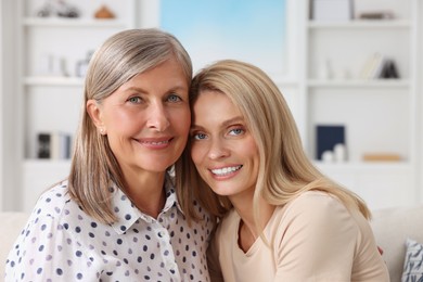 Photo of Happy mature mother and her daughter at home