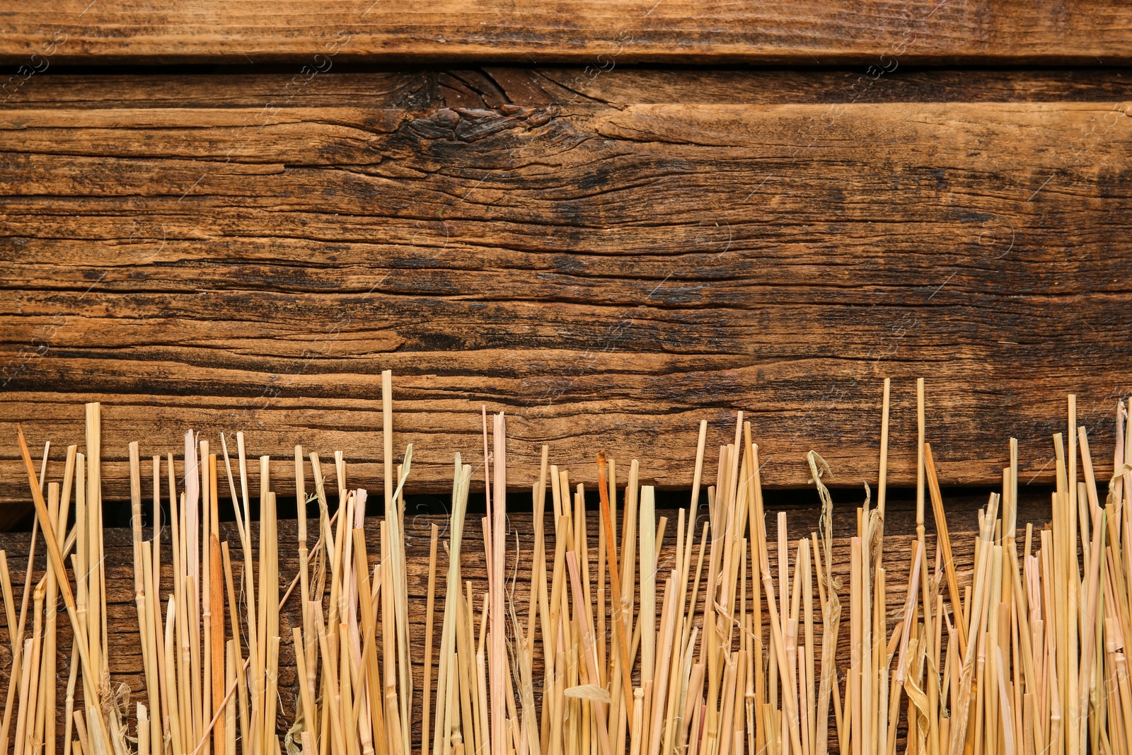 Photo of Dried hay on wooden background, flat lay. Space for text