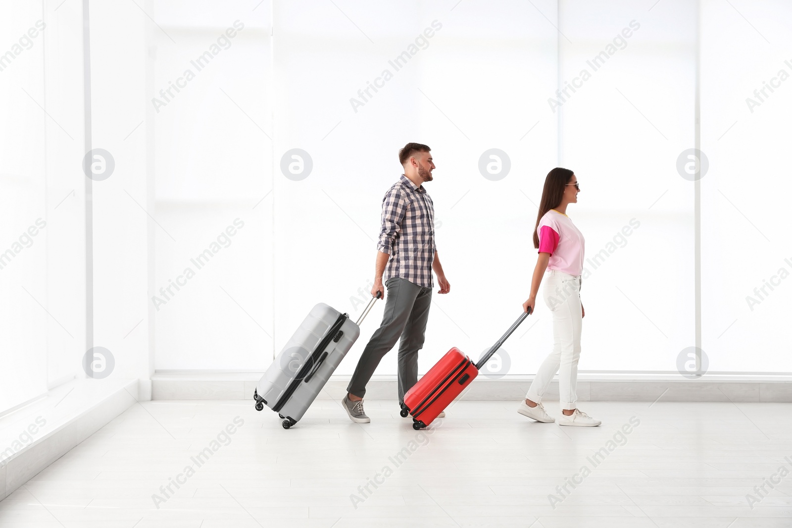 Photo of Young couple with suitcases in airport