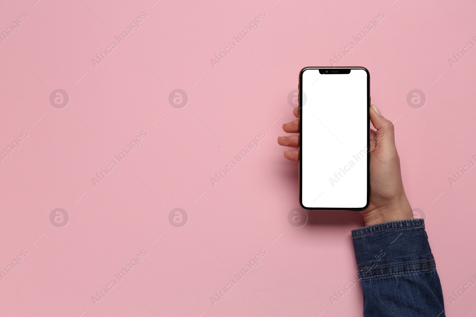 Photo of Woman with smartphone on pink background, top view. Space for text