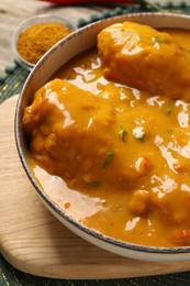 Photo of Tasty chicken curry and spice on table
