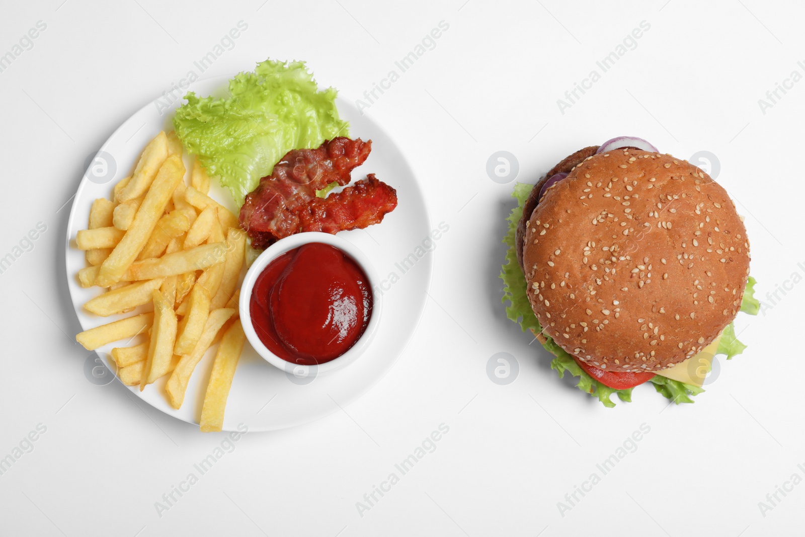 Photo of Fresh burger and plate with french fries on white background, top view