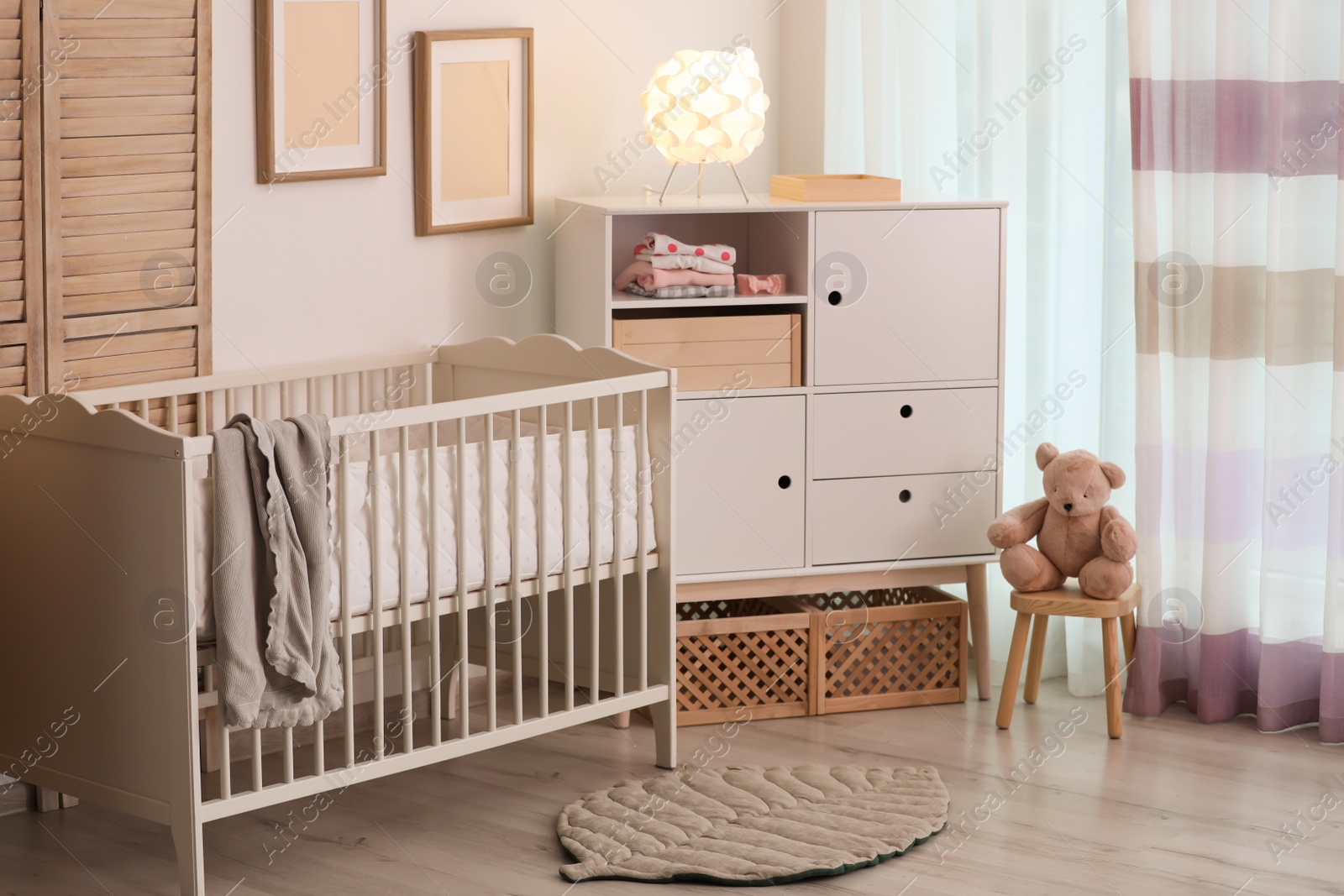 Photo of Modern room interior with crib and wooden crates under cupboard. Eco style