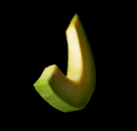 Photo of Slice of fresh avocado on black background