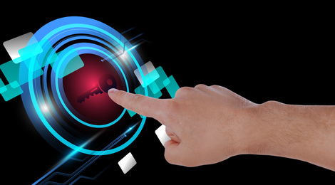 Image of Concept of keywords research and modern technology. Man pointing at key icon on black background, closeup